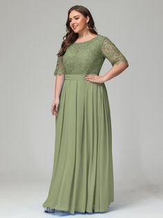 a woman in a long green dress with lace detailing on the shoulders and sleeves, posing for