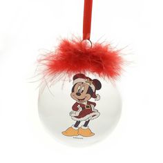 a glass ornament with a cartoon mickey mouse on it's face and red feathers