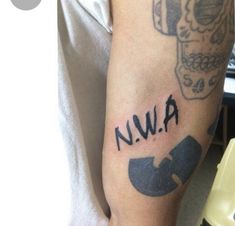 a man with a tattoo on his arm that reads nwa and has a wrench in it