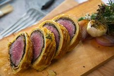 sliced meat and vegetables on a cutting board