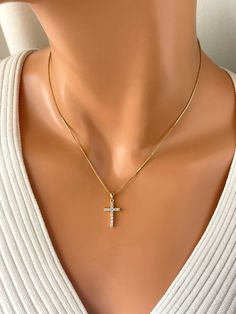 "This is 14kt gold filled crystal cross necklace. This lovely 14k gold filled box chain holds a 20x12mm, 14k gold filled cz cross charm that sparkles with tiny clear crystals. A spring clasp closure sits at the back of necklace.  Necklace may be ordered in a 16\", 18\" or 20\". Please note if you order 20 inch length you'll receive an 18 to 20 inch adjustable chain. Model has a small neck is wearing a 16 inch length." Cubic Zirconia Crucifix Jewelry Gift, Yellow Gold Cubic Zirconia Crucifix Jewelry, Yellow Gold Crucifix Jewelry With Cubic Zirconia, Gold Cubic Zirconia Cross Necklace As A Gift, Gold Plated Cross Necklace As A Gift, Cubic Zirconia Cross Pendant Jewelry For Gifts, Cross Pendant Jewelry Gift For Her, Cubic Zirconia Crucifix Necklace For Gift, Gold Diamond Cross Necklace As Gift