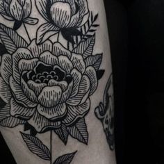 a black and white flower tattoo on the leg