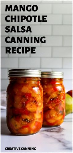 two jars filled with food sitting on top of a counter next to an apple slice