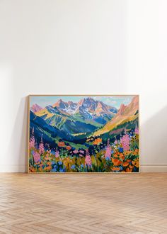 a painting is hanging on the wall in an empty room with hard wood flooring