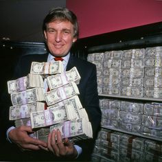 a man in a suit holding stacks of money