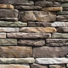 a stone wall made out of different colored rocks