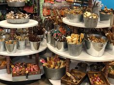 several metal buckets filled with different types of snacks