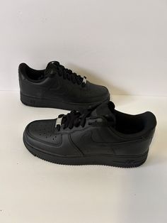 Elevate your sneaker game with these Nike Air Force 1 '07 Triple Black sneakers, perfect for any occasion. These shoes are designed with a low top shoe shaft style and standard shoe width, featuring a lace-up closure for a secure fit. The black color and colorful theme add a touch of elegance, making them a perfect fit for your activewear, casual wear, and workwear wardrobe. These sneakers are a women's size 8.5 with a UK shoe size of 6 and an EU shoe size of 40. They are part of the Nike Air Fo Shoes Black Women Sneakers, Black Af1s Outfit, Nike All Black Shoes, All Black School Shoes, Nike Air Force 1 Negras, Black Air Force 1 Outfit Women, Black Airforce 1, Black Air Force 1 Outfit, All Black Nike Shoes