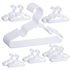 white plastic hangers and clips for clothes on a white background with clippings