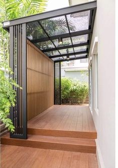 an open porch with wooden steps and metal railings