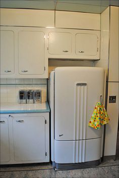 a white refrigerator freezer sitting inside of a kitchen