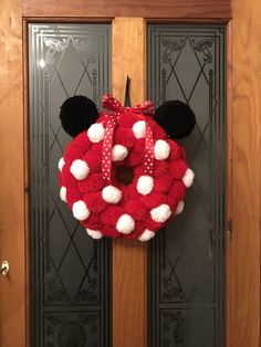 a mickey mouse wreath hanging on the front door