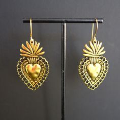 Gold Heart Earrings. Sacred heart earrings will be a stunning addition to your outfit.  Ear wires and charms are both gold plated. Lightweight and comfortable to wear, 2.25" x 1.00".  These Mystic Pieces delights will offer years of serenity in the love of Jesus Christ. The devotion to the Sacred Heart (also known as the Most Sacred Heart of Jesus , Sacratissimum Cor Iesu in Latin) is one of the most widely practices and well-known Catholic devotions, wherein the heart of Jesus is viewed as a symbol of "God's boundless and passionate love for mankind".  Wikipedia *SIZE* Length is 2.25 inches Width is 1.00 inch *FREE SHIPPING* I will get your lovely in the mail within 24 to 48 hours. Shipping is Monday through Friday and mailed USPS first class or priority mail. Tracking number will be sent Most Sacred Heart Of Jesus, Catholic Devotions, Gold Heart Earrings, Mexican Earrings, Gold Heart Earring, The Sacred Heart, Sacred Heart Of Jesus, Catholic Jewelry, Heart Of Jesus