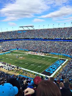 a football stadium filled with lots of people watching the game in blue and white colors