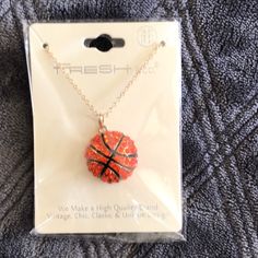 a necklace with a basketball on it