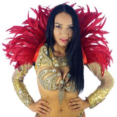 a woman in gold and red costume posing for the camera