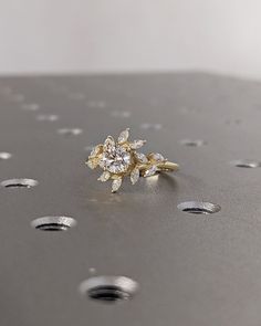 a diamond ring sitting on top of a metal surface