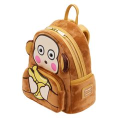 This stylish, banana scented mini backpack can fit a bunch of snacks and necessities. Monkichi sure has his hands full, but you could store your items in this bag to keep from juggling everything. The tan shoulder straps, zipper, handle, and trim accent the design perfectly. Don’t forget the banana enamel zipper charm! This bag is an officially licensed Sanrio product. Dimensions: W: 9" X H: 10.5" X D: 4.5" Material: Faux leather mini backpack Features: Adjustable shoulder straps, sturdy metal h Novelty Backpack For Daily Use, Novelty Standard Backpack For Daily Use, Novelty Backpack For Everyday Use, Stylish School Bags With Zipper Closure, Novelty School Bag With Zipper Closure, Novelty Yellow Bag For Everyday Use, Monkey Backpack, Sanrio Bag, Hello Kitty Merchandise