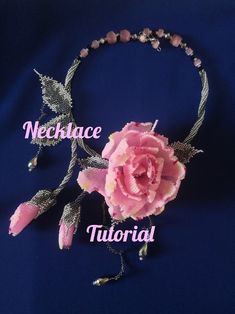 a pink flower is attached to a beaded headband with beads and metal leaves