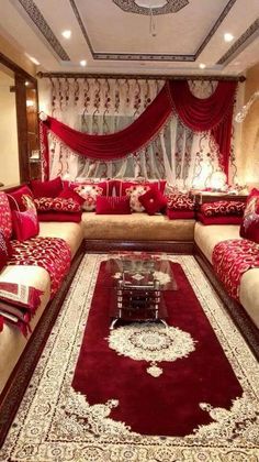 a living room filled with lots of red and white furniture