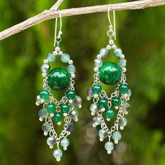 green and white beaded earrings hanging from a tree branch