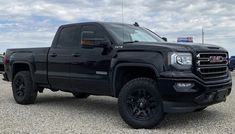 a black truck parked in a parking lot