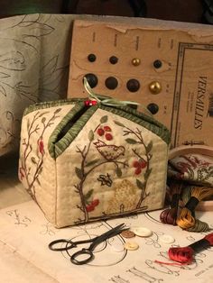 an assortment of sewing supplies are sitting on a table