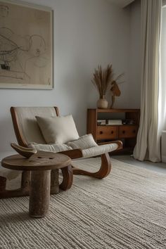 a living room with a couch, coffee table and large painting on the wall behind it