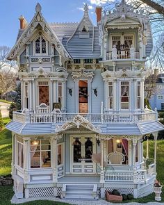 a large white victorian style house with lots of windows and balconies