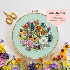 an embroidery kit with flowers and scissors on it