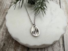 This charming hand stamped Woodland Trees Necklace is a  powerful symbol of life, growth, and renewal. Carry a little piece of the woods with you, no matter where life's journey takes you.   Want to make it extra special? I can engrave a personal message on the back. A date, name, or meaningful words - it's up to you! Each pendant is hand-stamped, not machine-made. I use metal stamps and a hammer to create each design. This means every piece is slightly different - that's the beauty of handmade Nature-inspired Stamped Jewelry For Everyday, Nature-inspired Etched Jewelry For Gifts, Nature-inspired Etched Jewelry Gift, Forest Necklace, Woodland Trees, Lover Jewelry, Stamp Ideas, Lovers Necklace, Woodland Forest