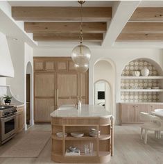 a kitchen with an island and wooden cabinets