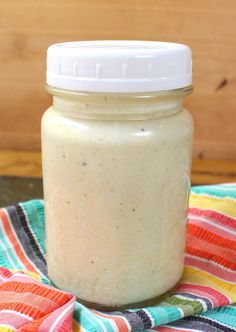 a jar filled with food sitting on top of a colorful towel