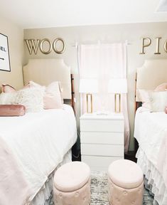 two twin beds in a bedroom with pink and white decor