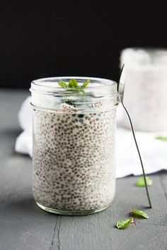 a glass jar filled with chia seeds on top of a wooden table