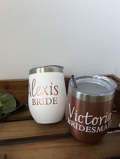 two bride tumblers sitting on top of a wooden table