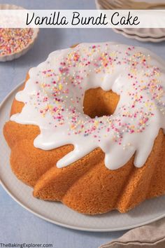 a bundt cake with white icing and sprinkles on a plate