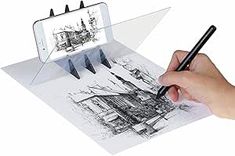 a person holding a pen and drawing on a piece of paper with an image in the background