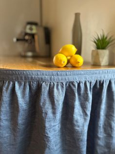 three lemons sitting on top of a table