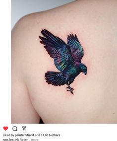 a black bird tattoo on the back of a woman's left shoulder and chest