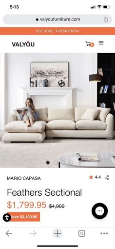 an image of a woman sitting on a couch in the middle of a living room