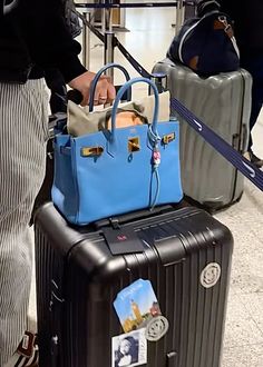 two pieces of luggage sitting on top of each other