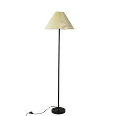 a floor lamp with a white shade on the base and a cord attached to it