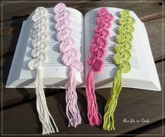 three crocheted tassels sitting on top of an open book