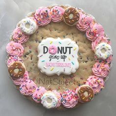 a donut cake with pink frosting and sprinkles on it that says donut grab up nutritiouse