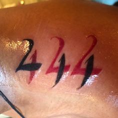 the back of a woman's shoulder with numbers painted on it and arrows pointing in different directions