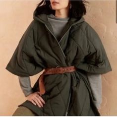 Oversized. Converts From Poncho To Shawl To Blanket. Hooded Quilted Poncho. Kimono Sleeves. Front Yoke. Zipper Closure. Three Button Side Closures. Double Welt Pockets. Straight Hem. Unlined. Please Note The Size Of This Jacket Is Labeled S-M And Meant To Be Worn Oversized. If You Wear A L-Xl The Jacket Will Fit. Oversized Cape Outerwear For Spring, Chic Oversized Outerwear With Batwing Sleeve, Green Cape Outerwear For Fall, Green Fall Cape Outerwear, Green Cape For Fall, Oversized Cape For Layering, Chic Winter Outerwear With Batwing Sleeve, Oversized Cold Weather Cape, Oversized Green Cape Outerwear