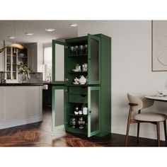 a green cabinet sitting in the middle of a kitchen next to a dining room table