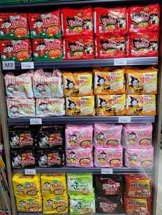 a display case filled with lots of different types of snacks and candy bars for sale