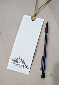 a pen and paper on a table next to a note with the word hello written on it